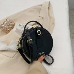 sac bandoulière rond cuir noir avec détail doré